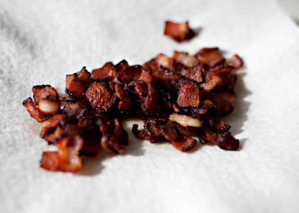 cooked bacon pieces on a paper towel to drain the grease