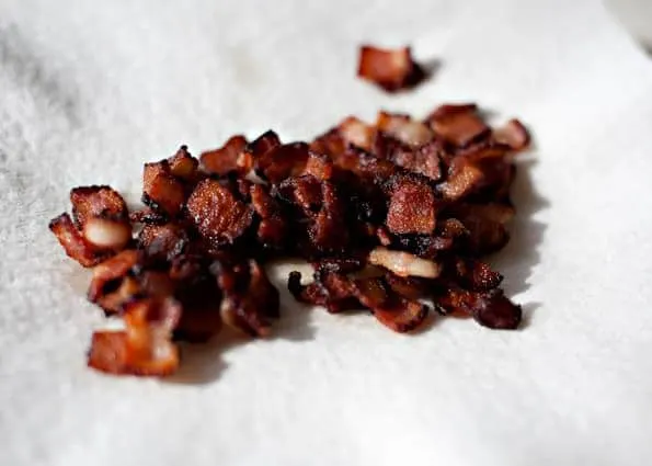 cooked bacon pieces on a paper towel to drain the grease