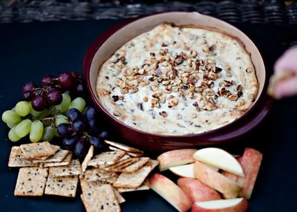 blue cheese bacon dip in a bowl with fruit and crackers