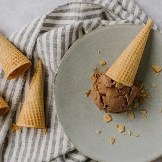 homemade chocolate ice cream cone laying down on a plate