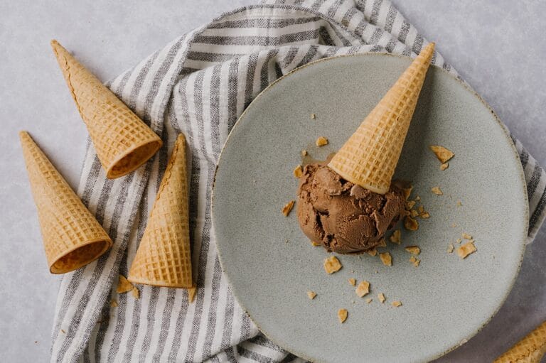 homemade chocolate ice cream cone laying down on a plate