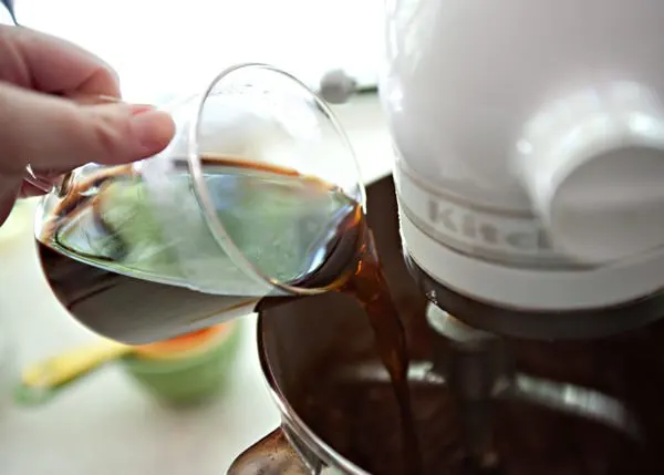 pouring coffee into chocolate cake batter
