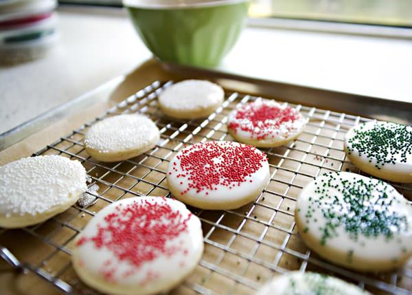 sugar cookies with sugar cookie glaze cooling on cooling rack