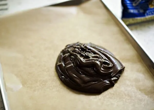 melted chocolate on parchment paper lined cookie sheet