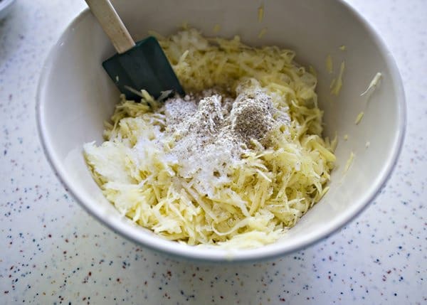 ingredients for potato latkes in a mixing bowl