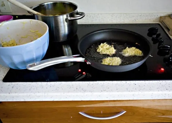 frying potato latkes in a pan