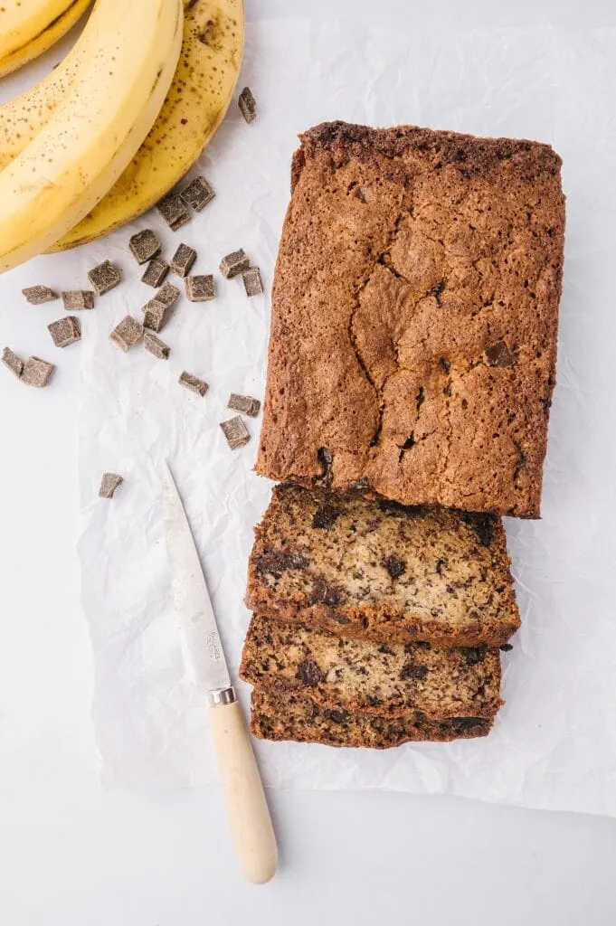 loaf of best banana bread ever sliced with chocolate chunks and bananas