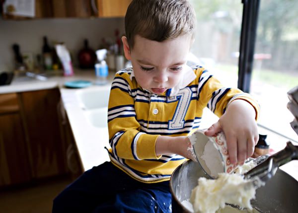 toddler boy making a sweet dessert for St. Patrick's Day