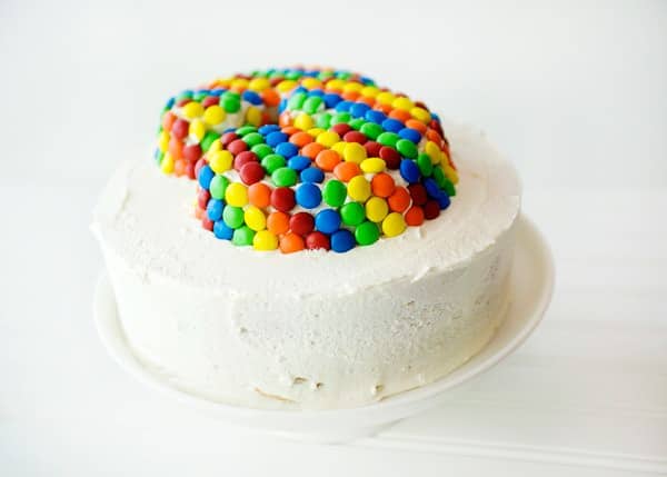 cake topped with marshmallow buttercream frosting and M&Ms
