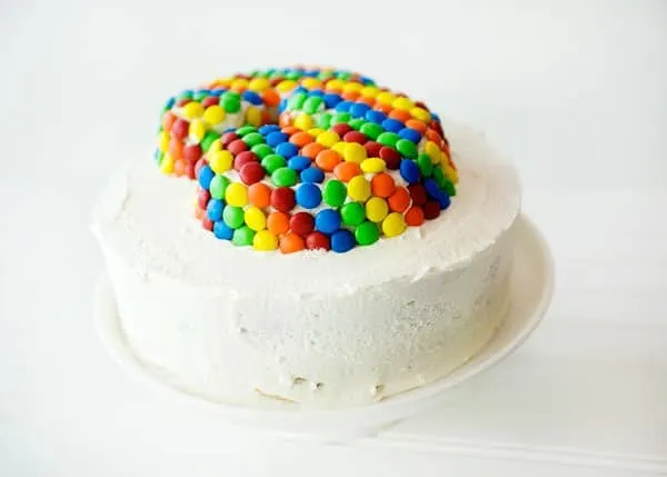 cake topped with marshmallow buttercream frosting and M&Ms