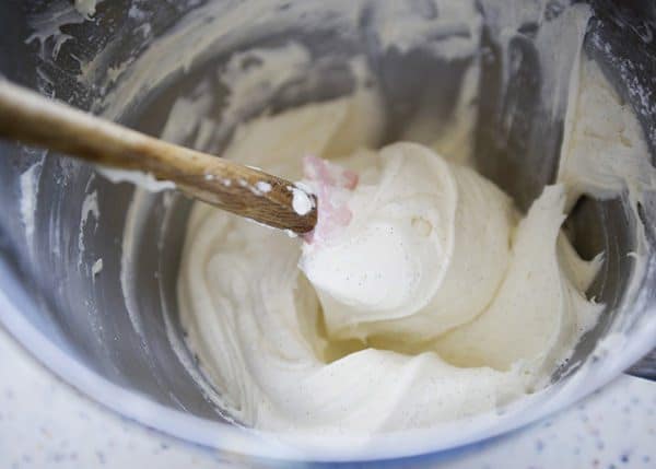 mixed ingredients for marshmallow buttercream frosting in a mixing bowl