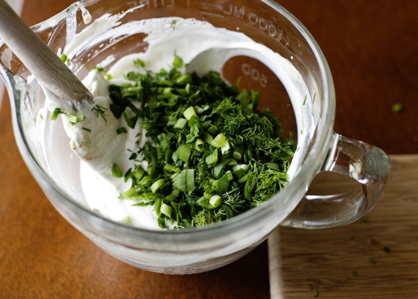 fresh herbs added to homemade ranch dressing recipe mix