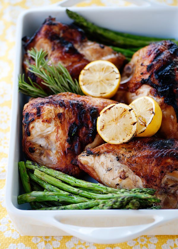 pan of sweet tea brined chicken and a side dish of asparagus spears