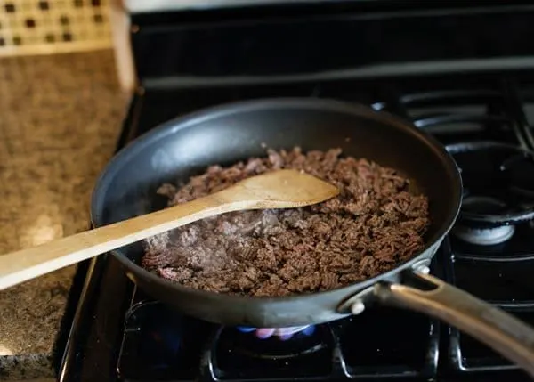 Ground beef cooking in a pan for lawnmower tacos