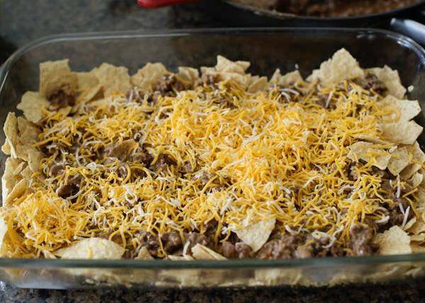 lawnmower tacos in a casserole dish ready to be baked