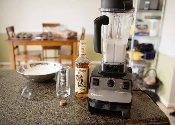 ingredients for spiced coconut rum shake with a blender