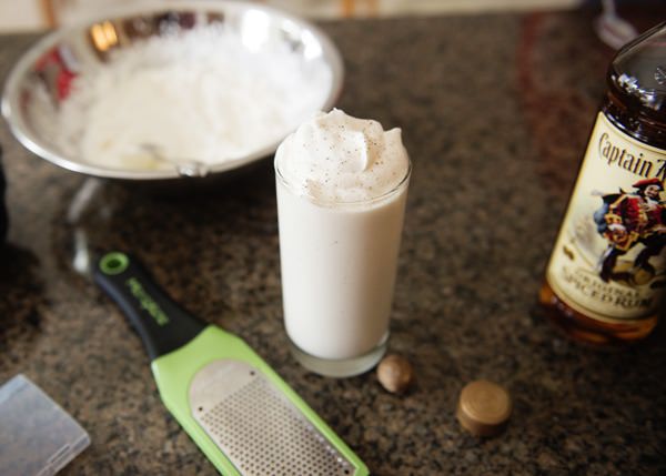 spiced coconut rum shake in a glass with sprinkled nutmeg