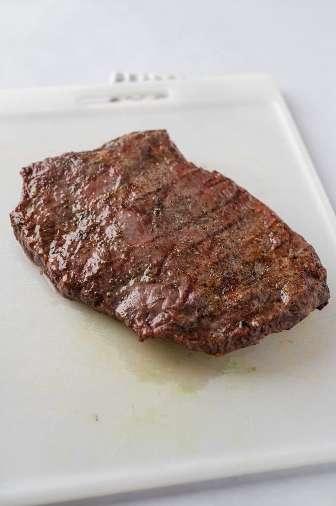freshly baked flank steak resting on a pan