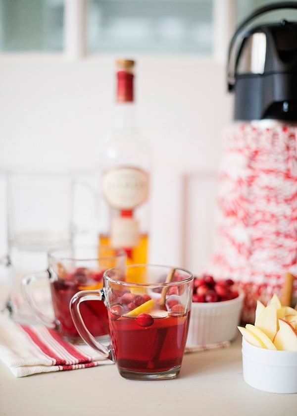 Close up of cranberry calvados cocktail with cranberries, calvados and lemons