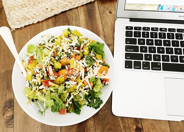 basil mint dressing on a salad beside a laptop