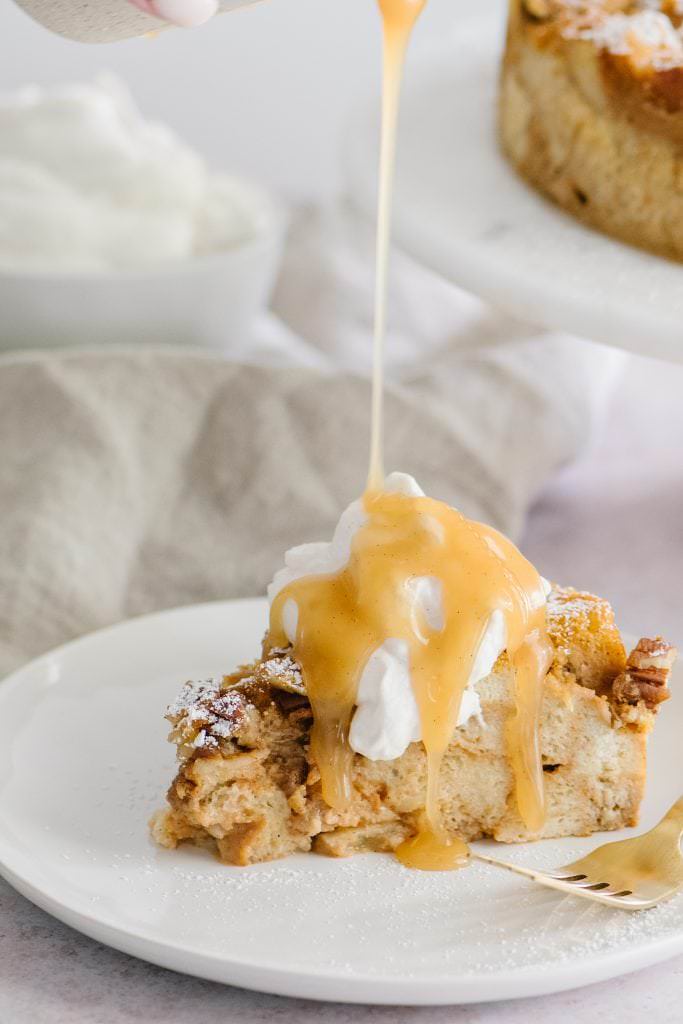 Pumpkin Bread Pudding with caramel sauce being poured over it