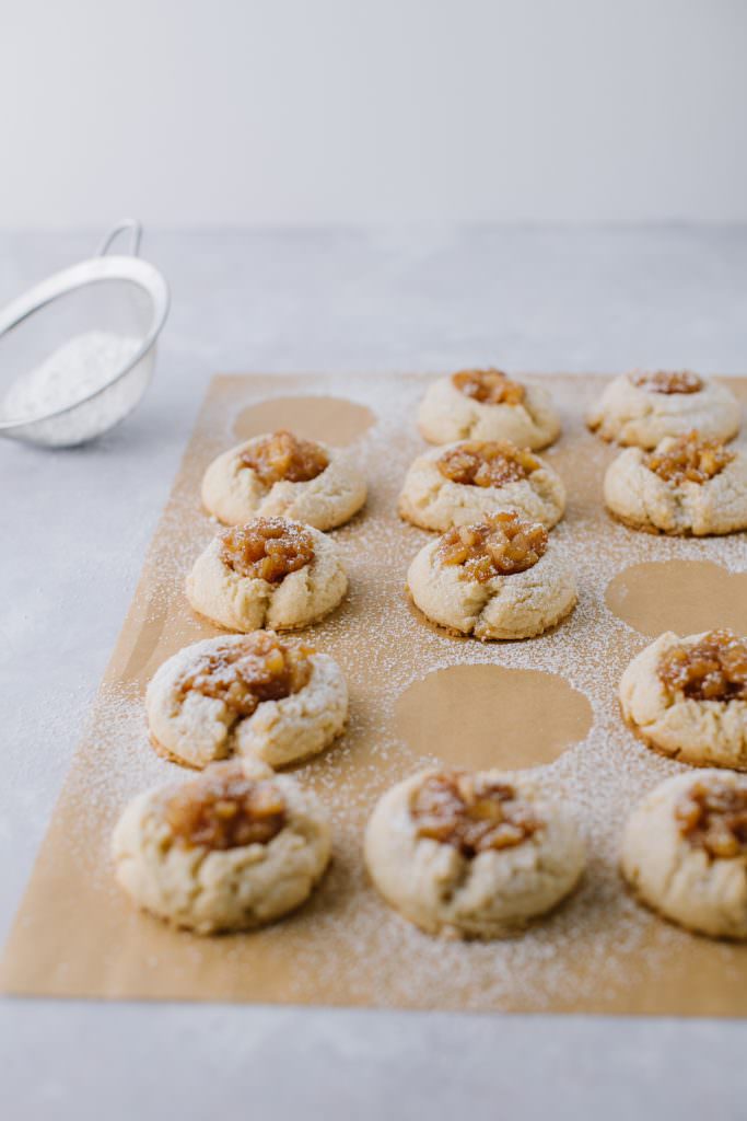 apple pie thumbprint cookies on a baking sheet