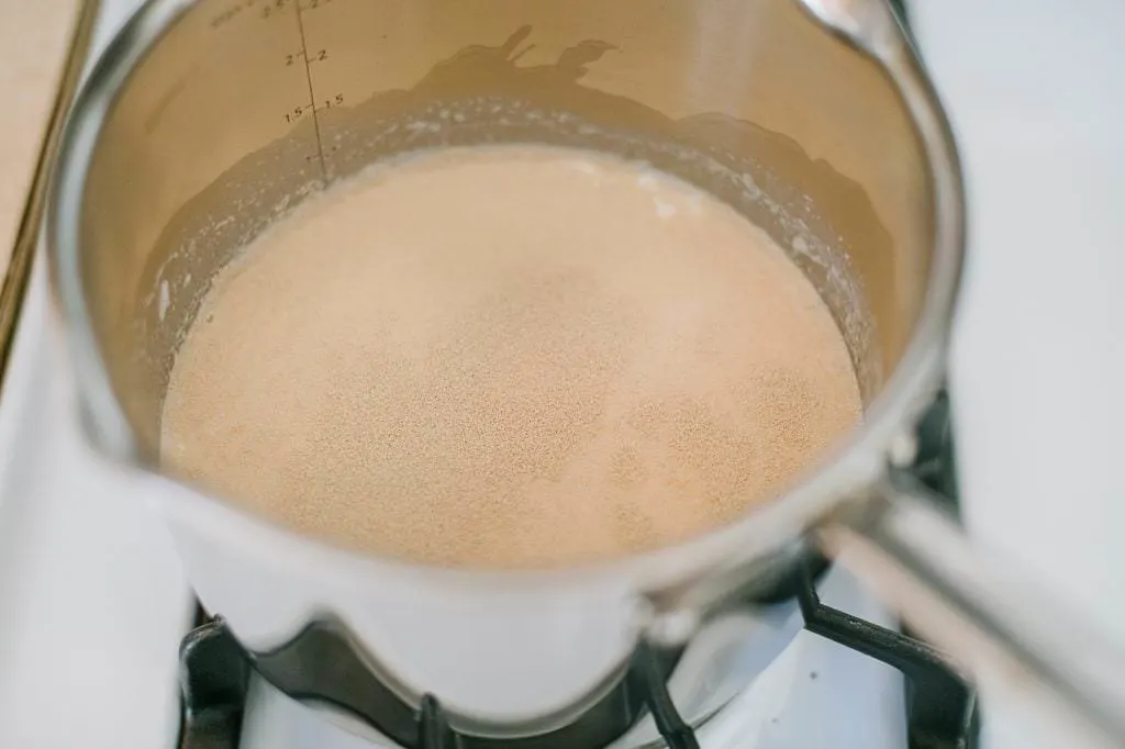 milk on the stove with yeast