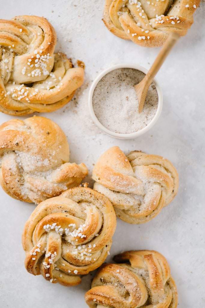 close up of cardamom buns with sugar bowl and spoon