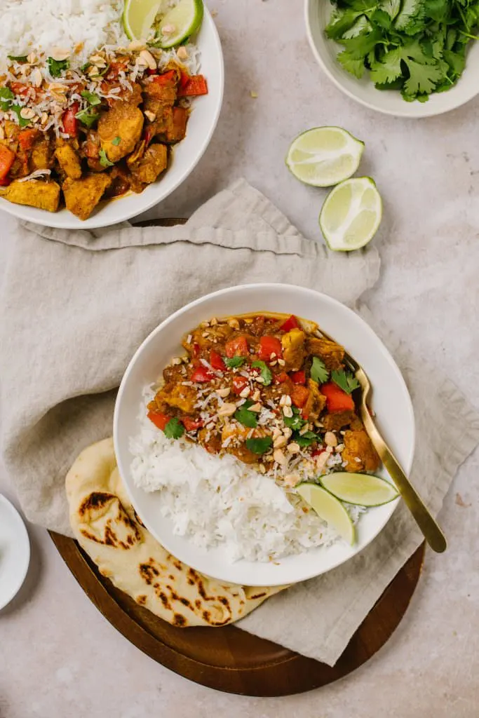 curry recipe with naan in a bowl with a spoon