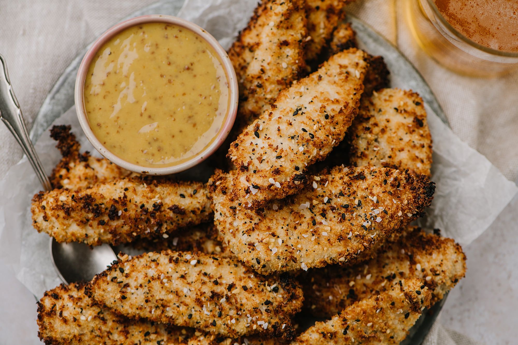 Air Fryer Everything Chicken Fingers with Honey Mustard Dip on a plate