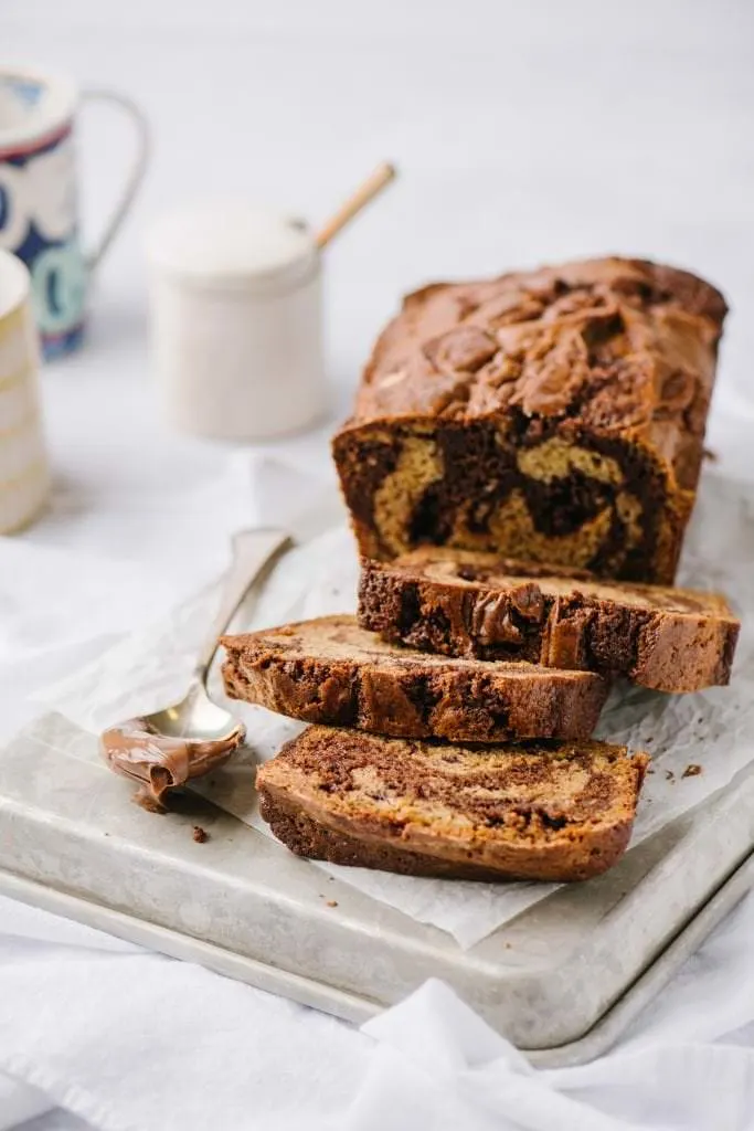 sliced banana loaf with nutella swirl and a spoon