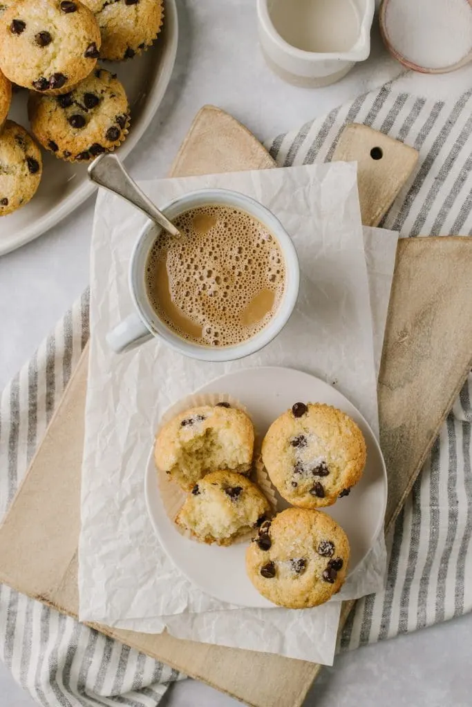 a cup of coffee with chocolate chip muffins