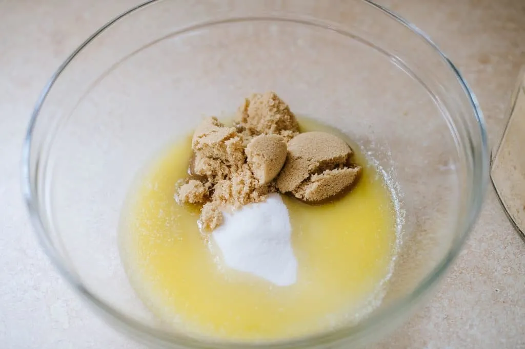 melted butter, sugar and brown sugar in glass bowl