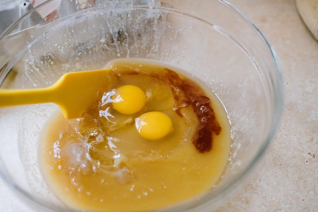 melted butter, sugar, eggs and vanilla in glass bowl