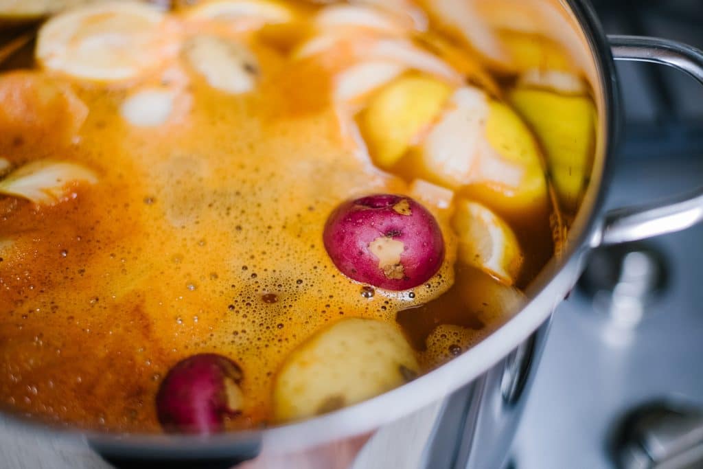 potatoes, onions and lemon simmering in spicy stock in large pot