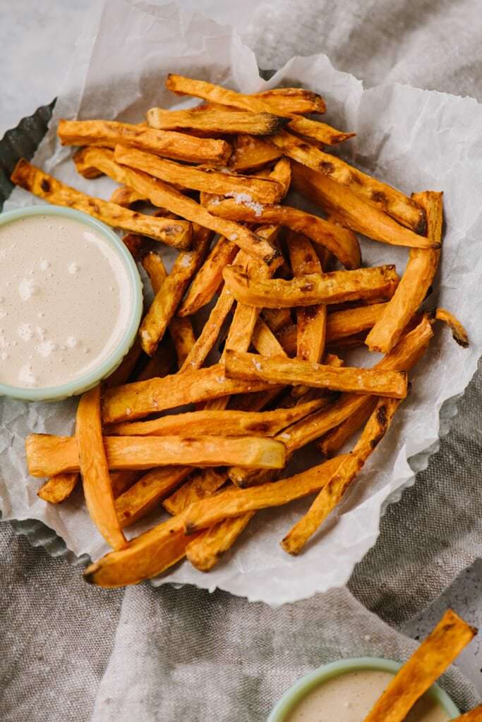 bowlful of baked sweet potato fries with toasted marshmallow dip on side