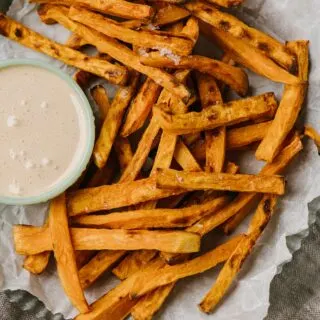 bowlful of baked sweet potato fries with toasted marshmallow dip on side