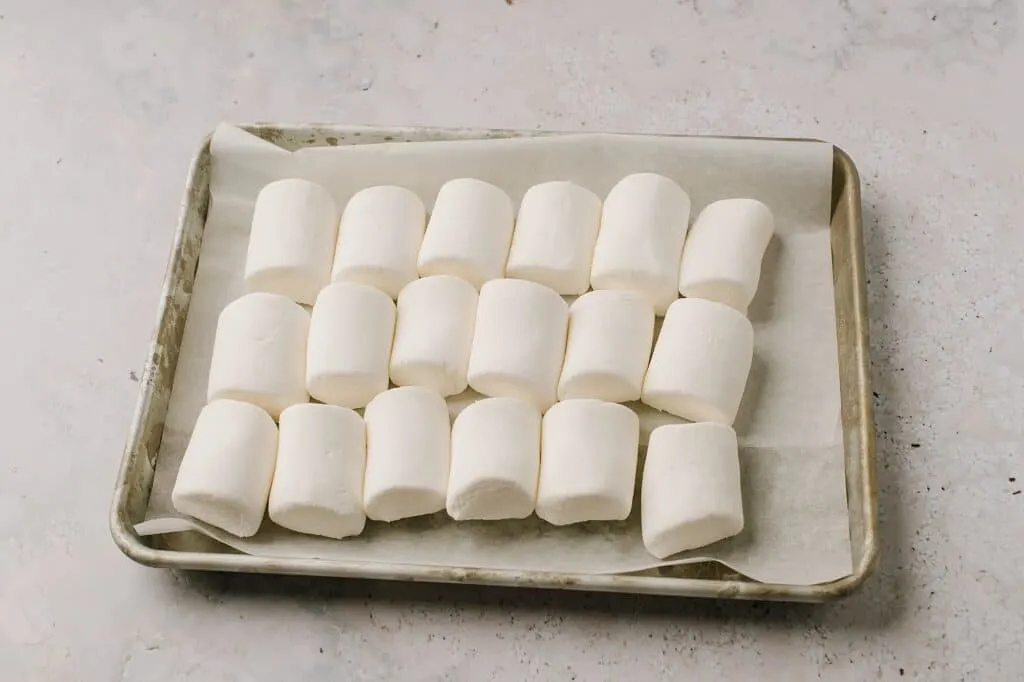 jumbo marshmallows lined up on baking sheet