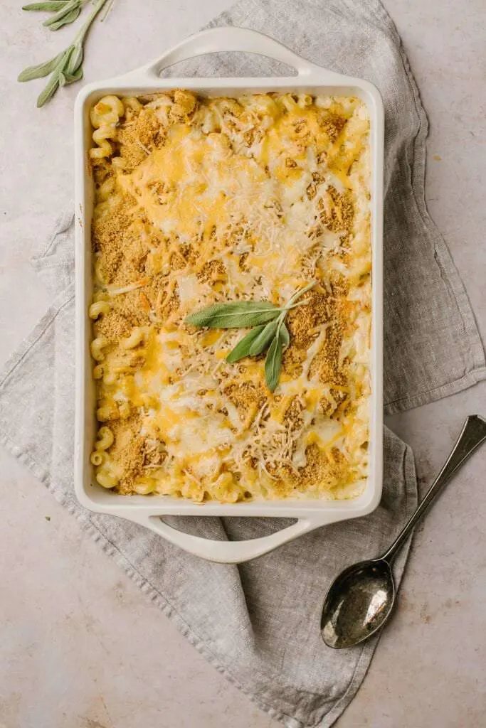 baked squash and sage macaroni and cheese in white baking dish