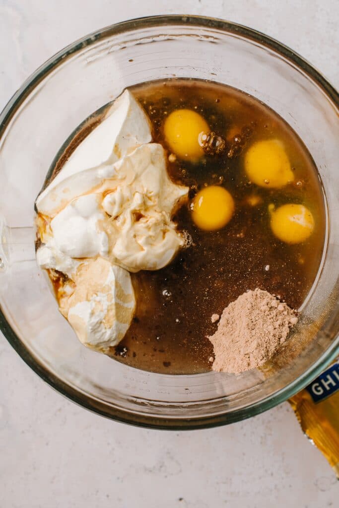 boxed cake mix, eggs, sour cream in glass bowl