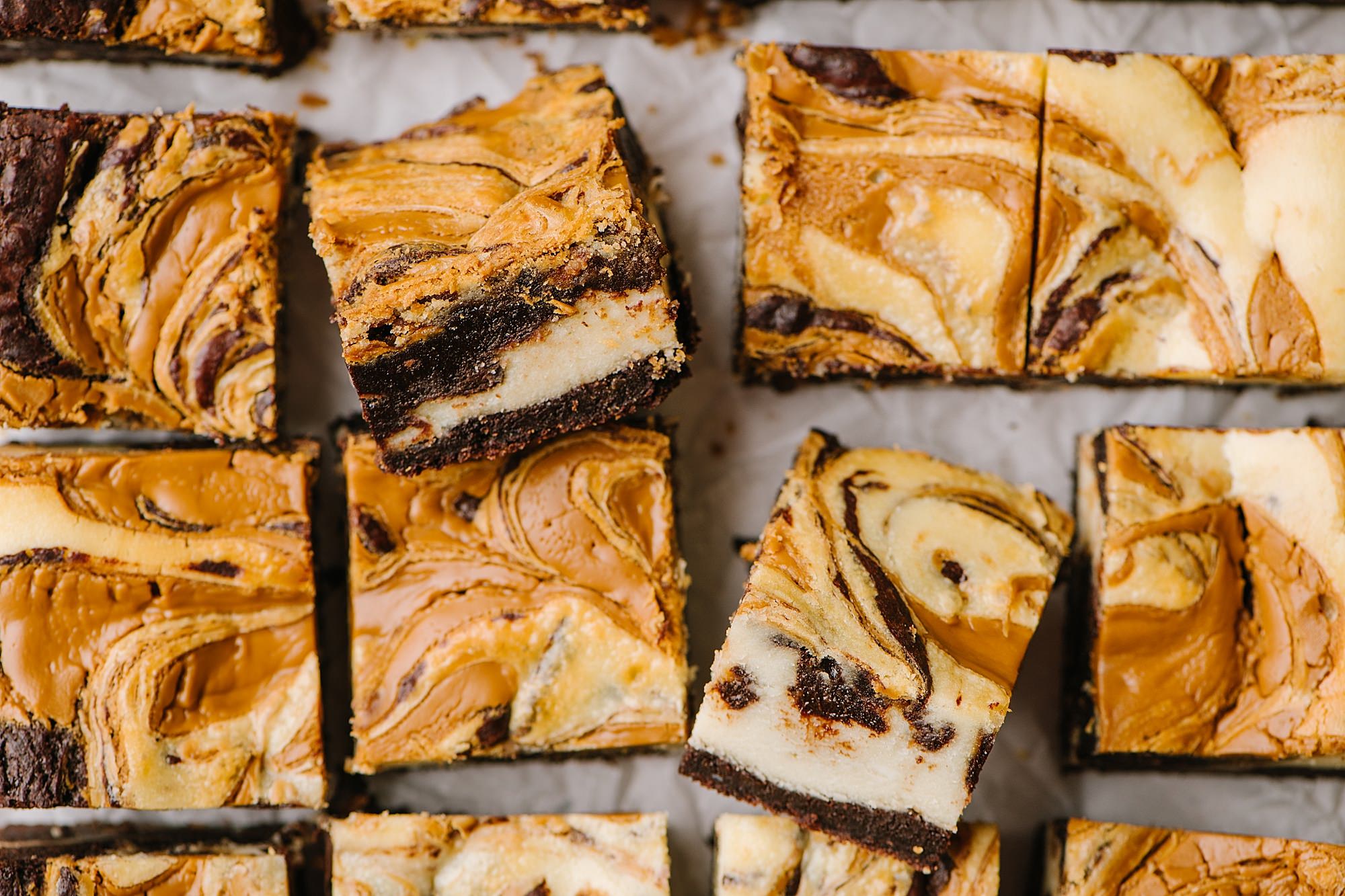 overhead shot of cookie butter cheesecake brownies with two turned on side