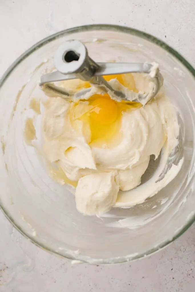 egg and cream cheese mix in glass bowl with paddle