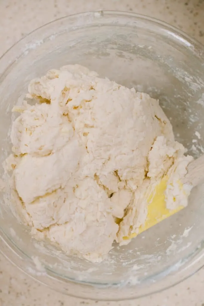 mixing dumpling dough with yellow spatula