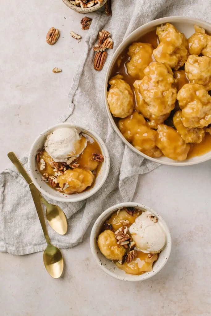maple dumplings topped with vanilla ice cream and large bowl of grandperes on side