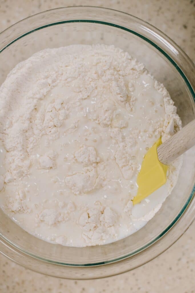 mixing buttermilk into dumpling dough