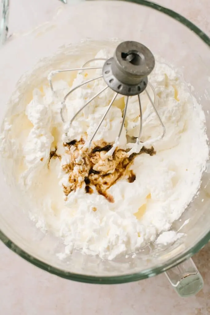 vanilla over whipped cream in glass bowl
