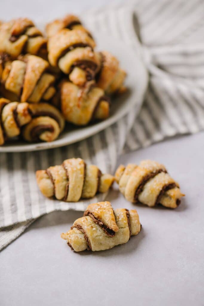 Three small chocolate cinnamon rugelachs, rolled into beautiful crescent shapes. 