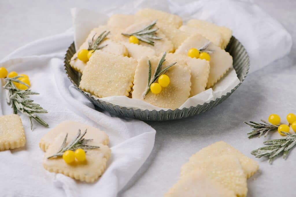 A plate of lemon rosemary cut out cookies on a plate