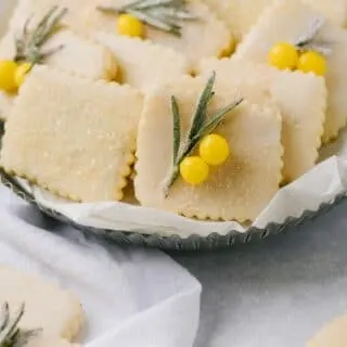 This is a plate of lemon rosemary cookies, decorated with rosemary.