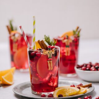 Glasses of mulled red wine sangria, with fruit and garnishes.
